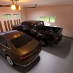 a spacious 2-car garage with modern black doors, built-in storage cabinets, and a durable grey epoxy floor