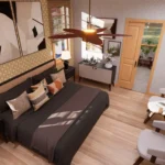 Primary bedroom in cottage house with ensuite bathroom, natural light, modern decor, wooden flooring, and cozy seating