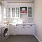 laundry room with white shaker cabinets, a natural wood countertop, and a deep white farmhouse utility sink