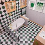 Modern cottage bathroom with freestanding bathtub, black and green checkered tile flooring, glass shower, and double vanity