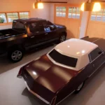 Two car garage interior with classic and modern vehicles, overhead lighting, smooth concrete floor, and wooden garage doors